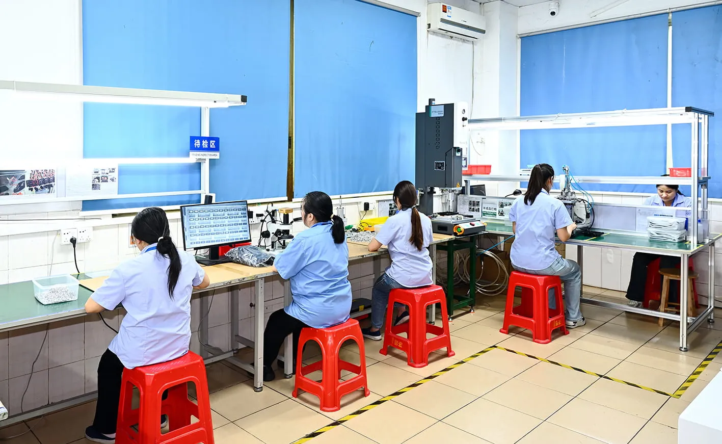 Final inspection line where molded consumer-goods parts are checked before packing