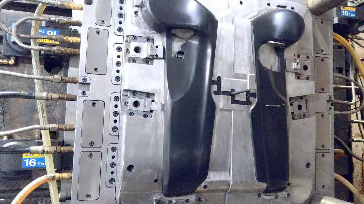 Console component mold photographed on the assembly bench