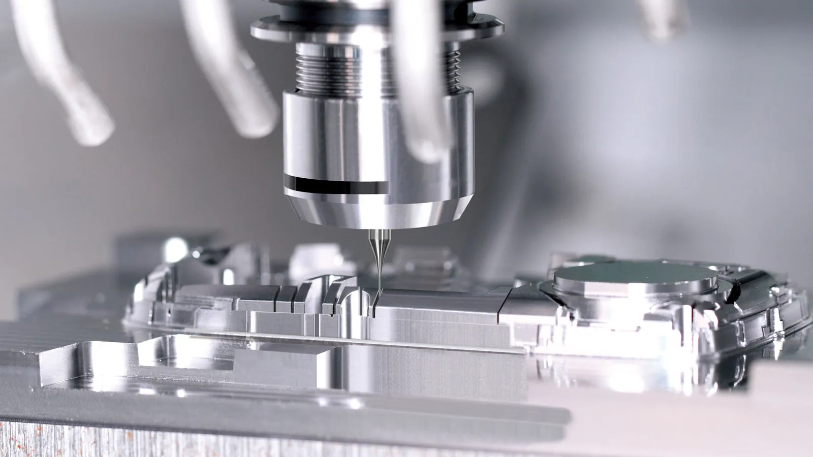 CNC end mill cutting mold steel for a plastic housing tool — milled pockets and core boss in close-up