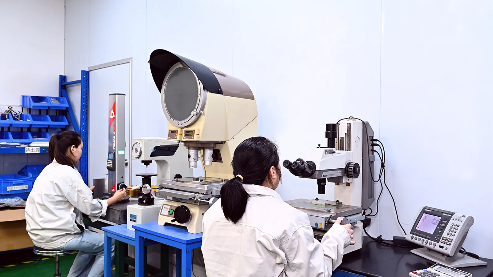 Toolmaker's microscope and height gauge at the metrology bench