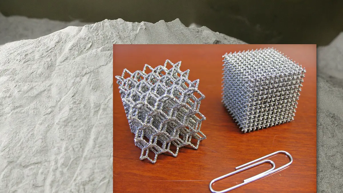 Metal-printed lattice cubes beside atomized metal powder